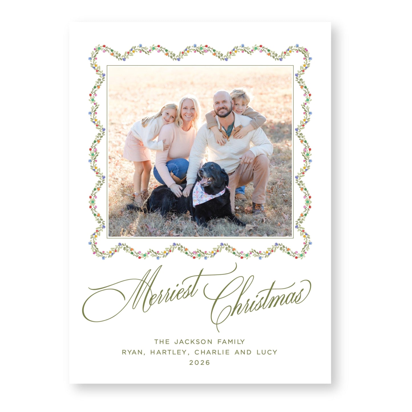 A family portrait of a man, woman, and two children, with a dog in the background, all smiling and posing together. The text at the bottom of the image reads "Merry Christmas THE JACKSON FAMILY RYAN, HARTLEY, CHARLIE AND LUCY 2026".