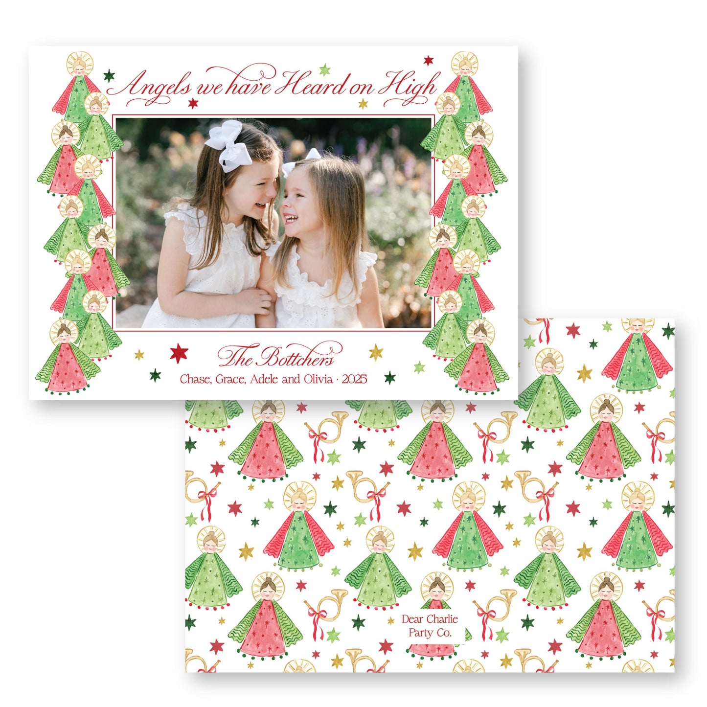 The image is a Christmas card featuring two young girls in white dresses, surrounded by a festive pattern of green and red angels and stars.