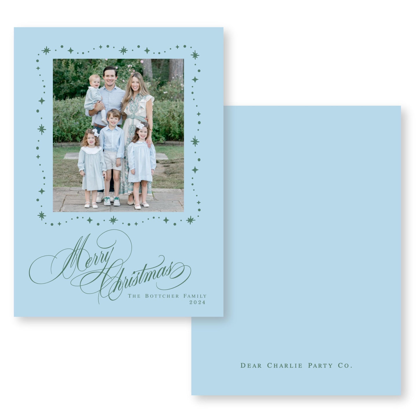 A family photo of a man, woman, and three children dressed in light blue clothing, standing together in a garden setting. The text on the card reads "Merry Christmas" and "The Botcher Family" along with the year "2004".