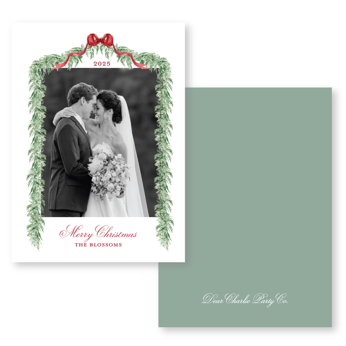 A black and white photograph of a bride and groom embracing, framed by a green wreath and the text "Merry Christmas THE BLOSSOMS".