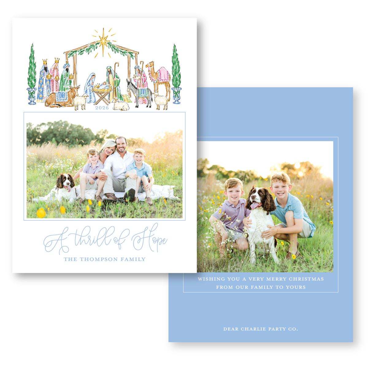 The image is a holiday card featuring a family portrait of a man, woman, and two children, along with a nativity scene and a dog. The card has a blue background with white text and graphics.