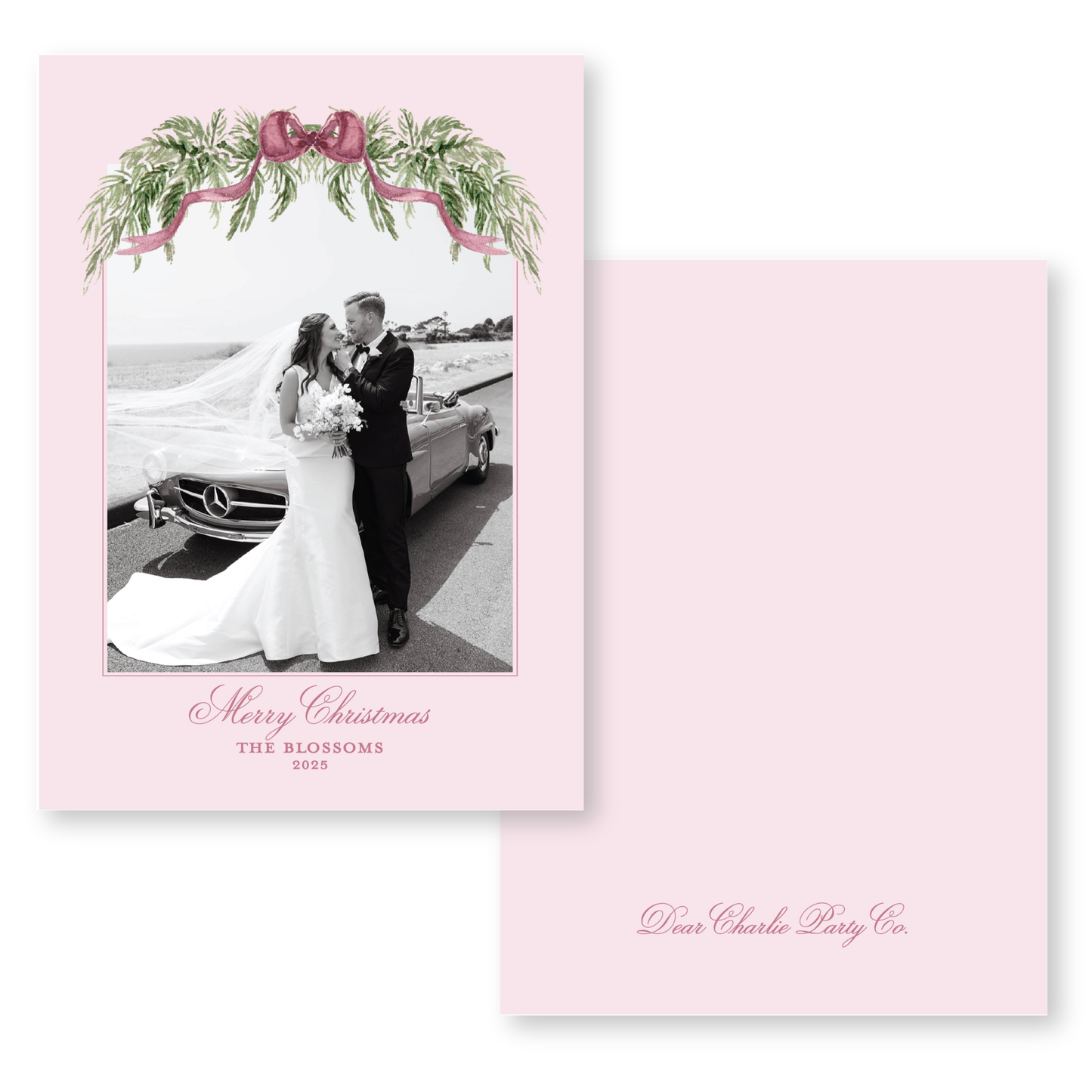 A black and white photo of a bride and groom standing next to a car, with a pink border and a decorative floral arrangement above them. The text "Merry Christmas" and "THE BLOSSOMS 2015" is displayed, along with the name "Dear Charlie Party Co."