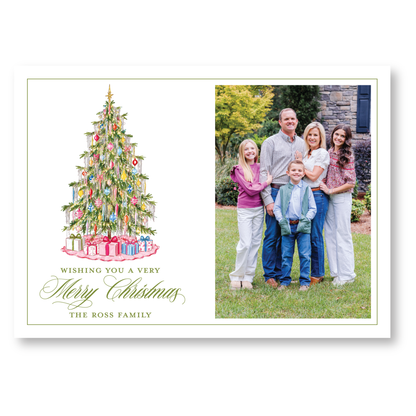 A family portrait of the Ross family, with a Christmas tree in the background and a message wishing them a very Merry Christmas.
