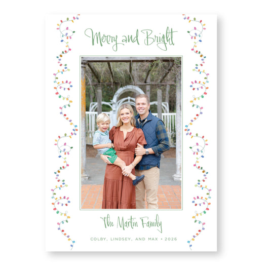 A family portrait of a man, woman, and child, with the text &quot;Merry and Bright&quot; and &quot;The Martin Family&quot; written above and below the photo.