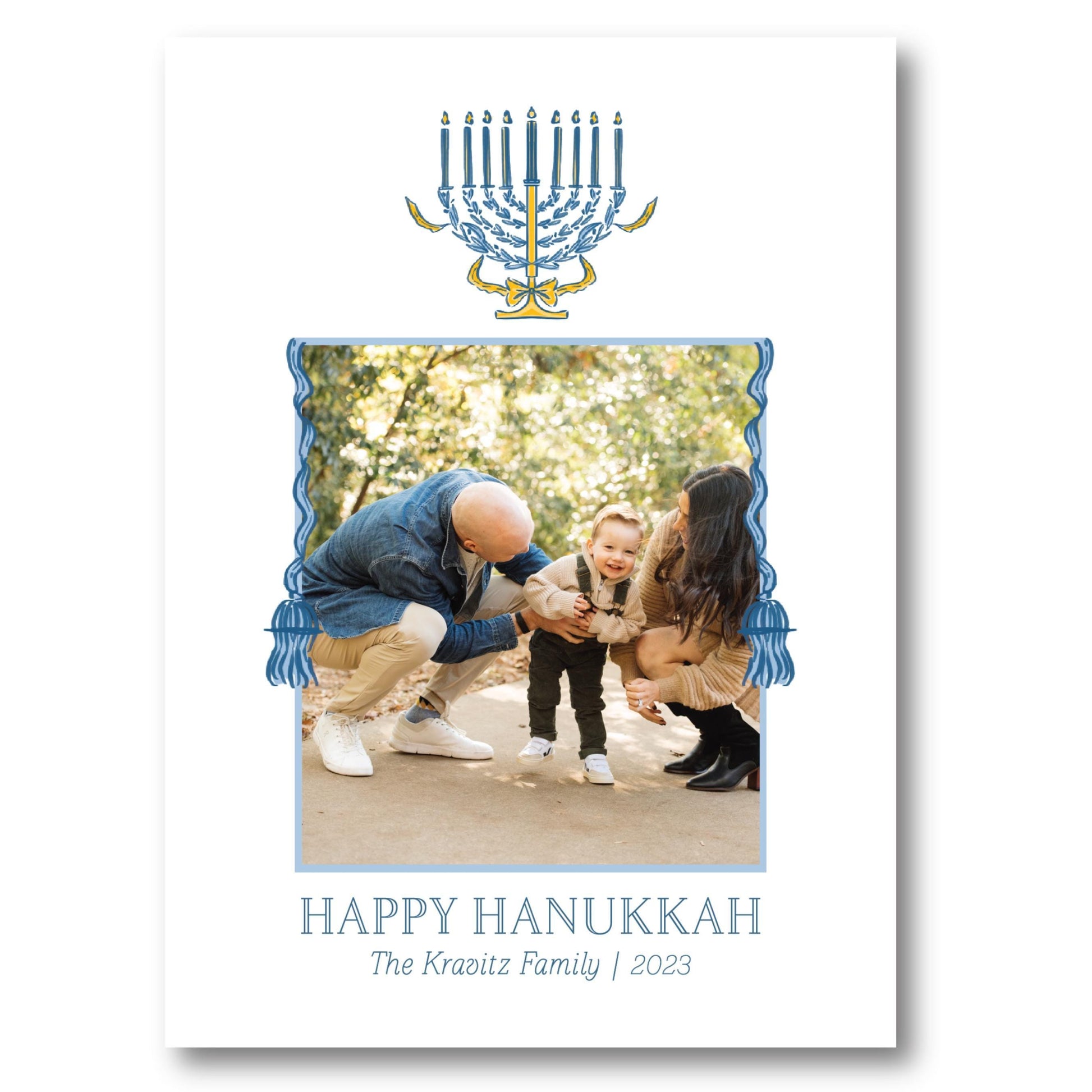 a happy hanukkah card with a picture of a man holding a baby