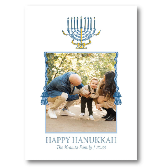 a happy hanukkah card with a picture of a man holding a baby