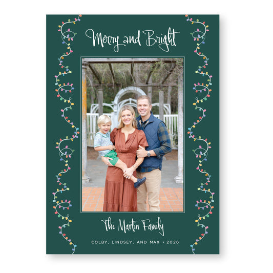 A family portrait of a man, woman, and child, with the text &quot;Merry and Bright&quot; and &quot;The Martin Family&quot; written around the edges of the frame.