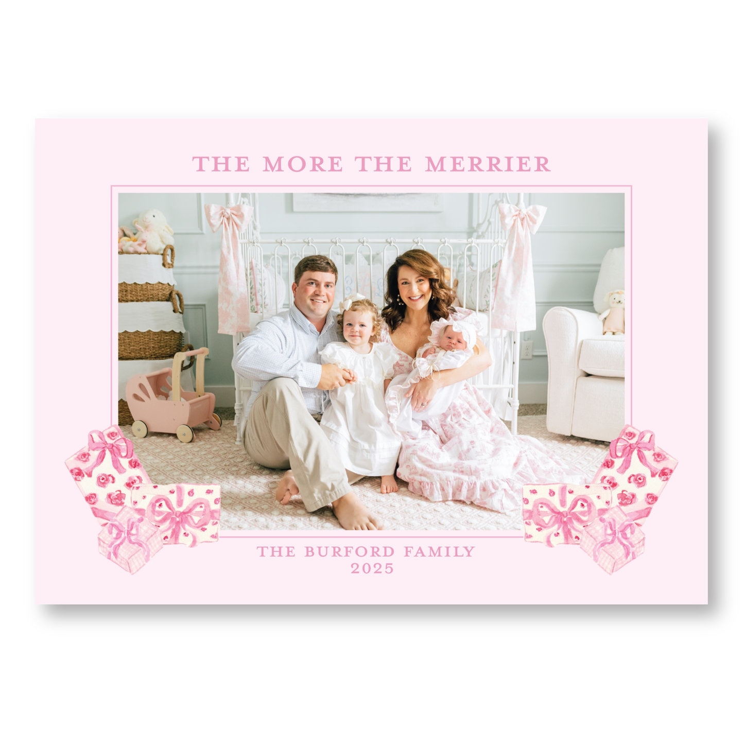 A family portrait of a couple and their two young children, taken in a nursery setting with a crib and toys.