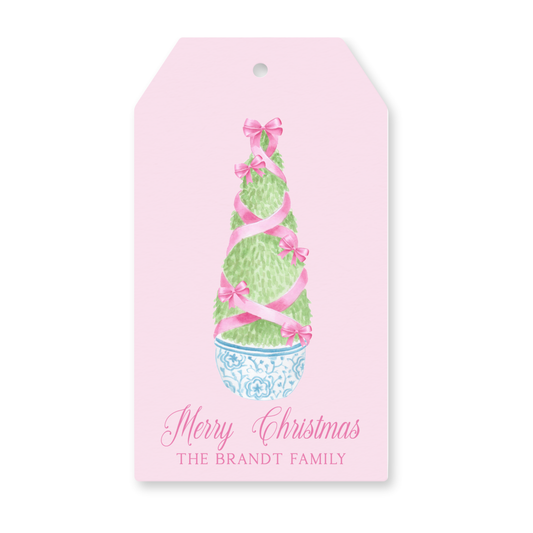 a pink gift tag with a christmas tree on it