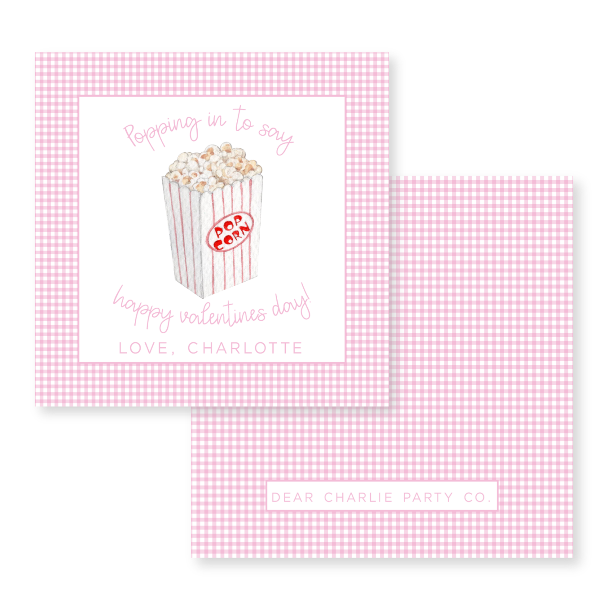 a pink and white checkered card with a box of popcorn