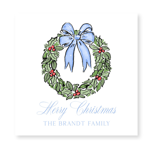 a christmas card with a blue bow and holly wreath