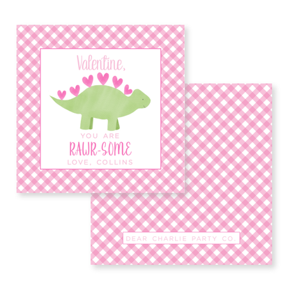 a pink and white checkered table cloth with a green dinosaur on it