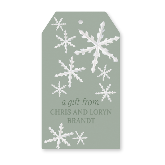a gift tag with snowflakes on it