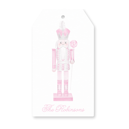 a pink and white christmas ornament with a nutcracker