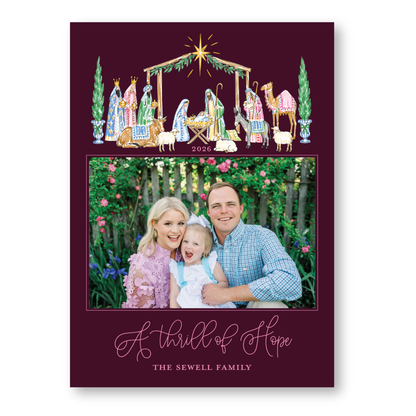 A family portrait of a man, woman, and child, with a nativity scene and a star above them, and the text "A Thrill of Hope" and "THE SEWELL FAMILY" at the bottom.