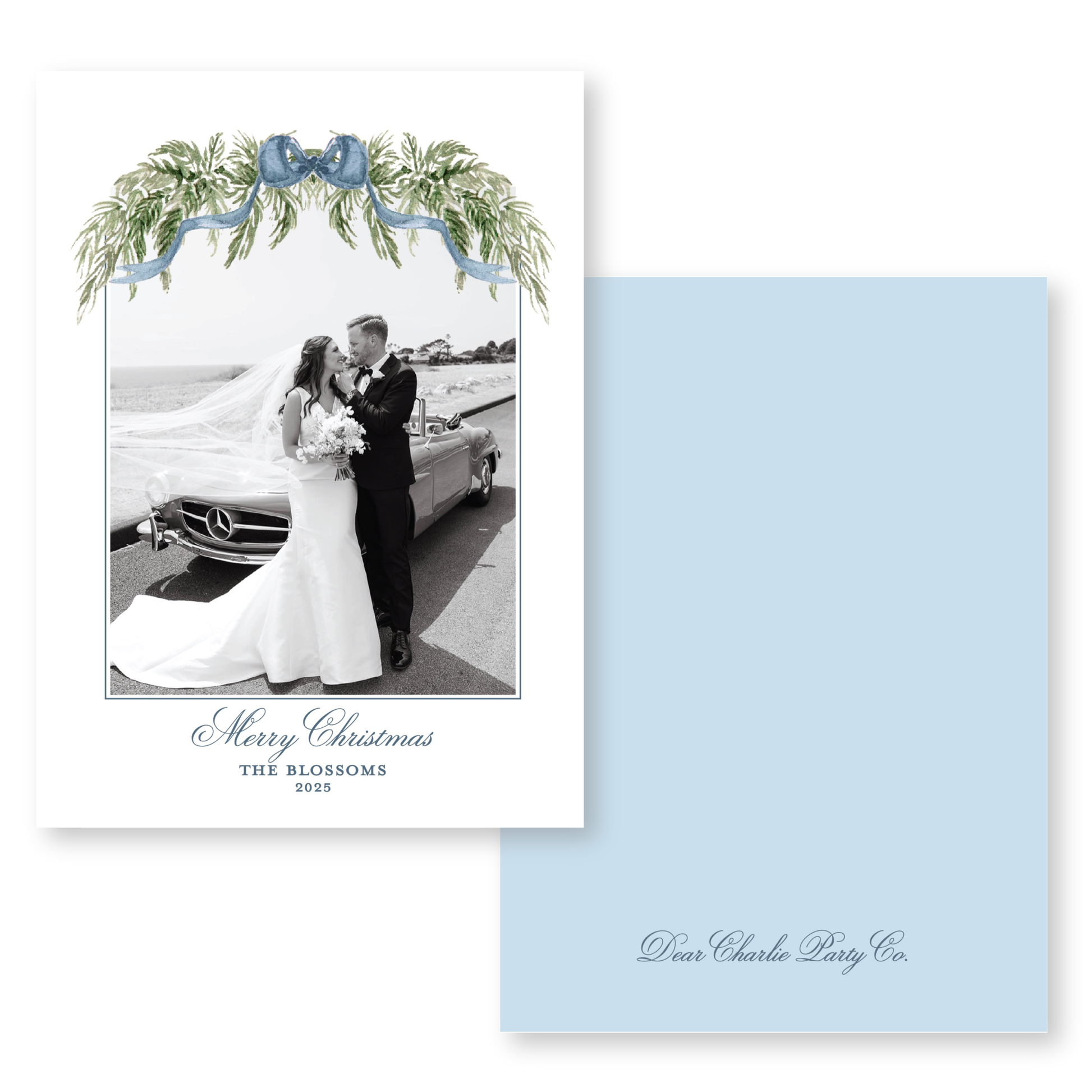 A black and white photograph of a bride and groom standing next to a car, with a blue ribbon and greenery decorating the frame. The text "Merry Christmas" and "THE BLOSSOMS" is visible, along with the year "2025" and the name "Dear Charlie Party Co."