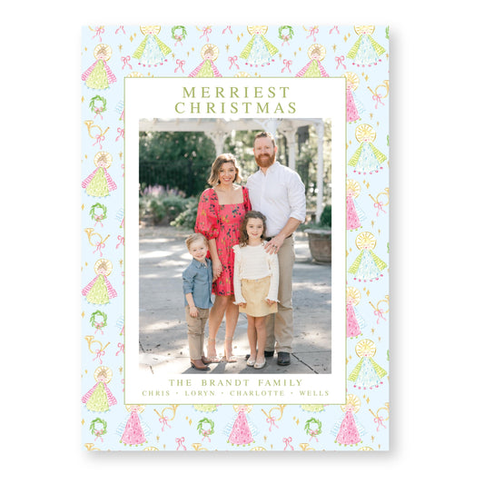 A family portrait of a couple and their three children, taken outdoors in a garden setting.
