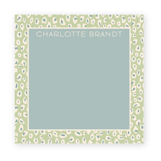 a green and white leopard print frame with the word charlotte brand