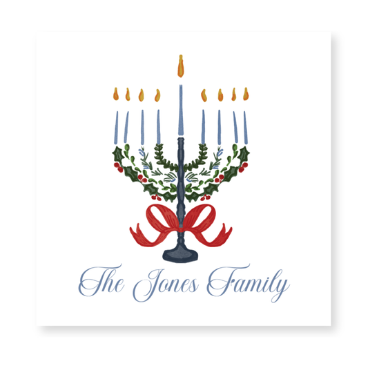 a holiday card with a candle and holly wreath