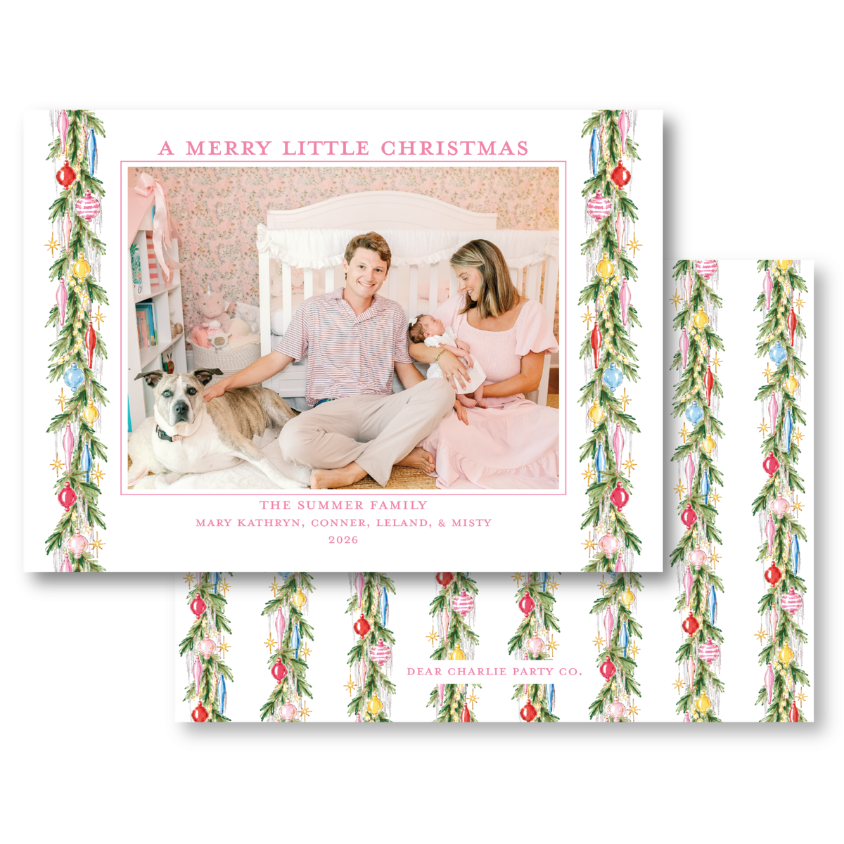 A family portrait of a couple and their two children, with a dog in the background, is displayed on a Christmas-themed card.