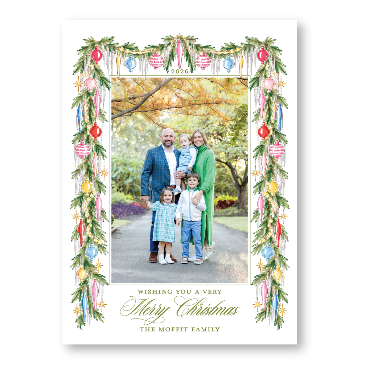 A family portrait of a man, woman, and two children, surrounded by a festive wreath and ornaments, with a message wishing the recipient a very Merry Christmas.
