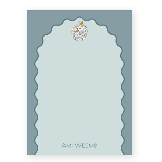 a card with an apple on top of it
