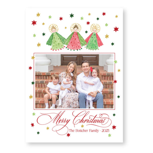 A family photo of a man, woman, and two children sitting on steps, surrounded by Christmas decorations and stars.