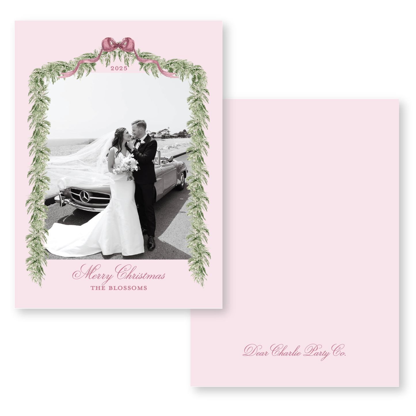 A black and white photograph of a bride and groom standing next to a car, framed by a decorative border with greenery and a ribbon. The text on the card reads "Merry Christmas THE BLOSSOMS" and "Dear Charlie Party Co."